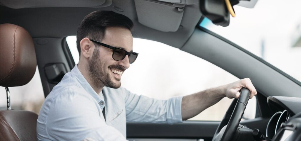 Man wearing sunglasses while in the car