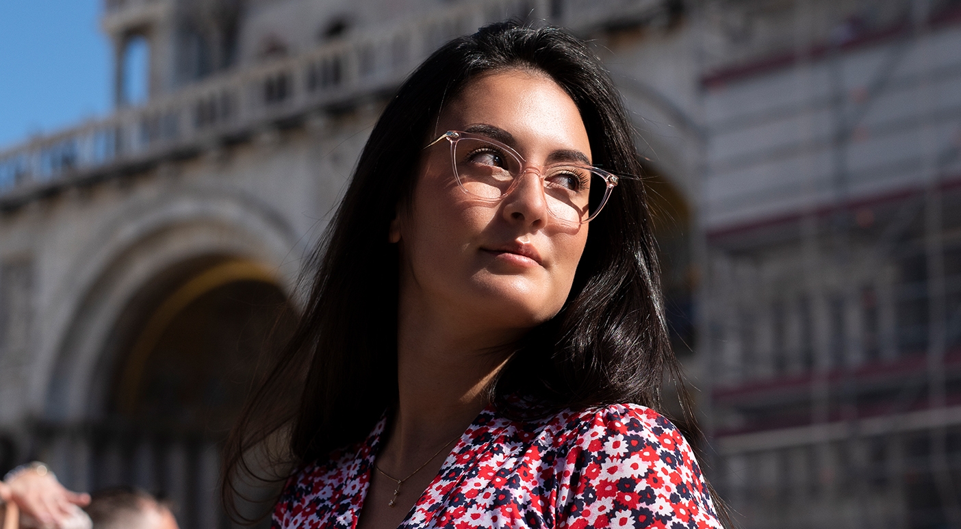 A woman wearing Moretta glasses on a sunny day in Italy