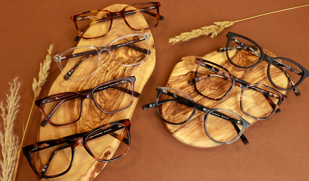 Collection of Arden frames on wooden boards with wheat placed on a brown background