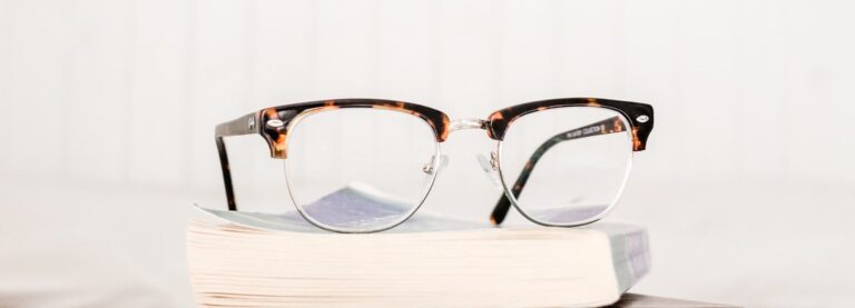 Clubmaster Tortoiseshell frames on a pile of books