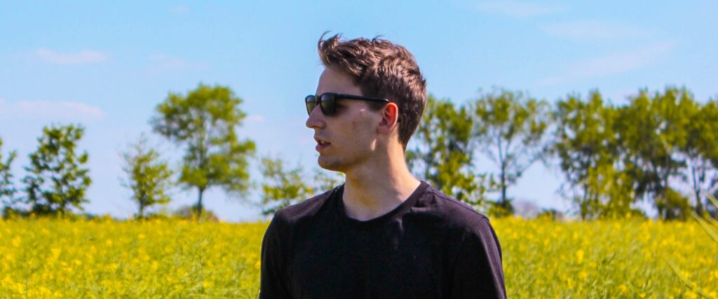 Man wearing sunglasses in a field