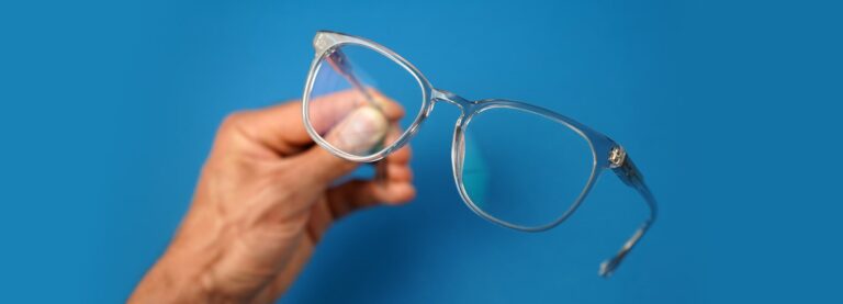 Pair of blue varifocal glasses head up by a hand