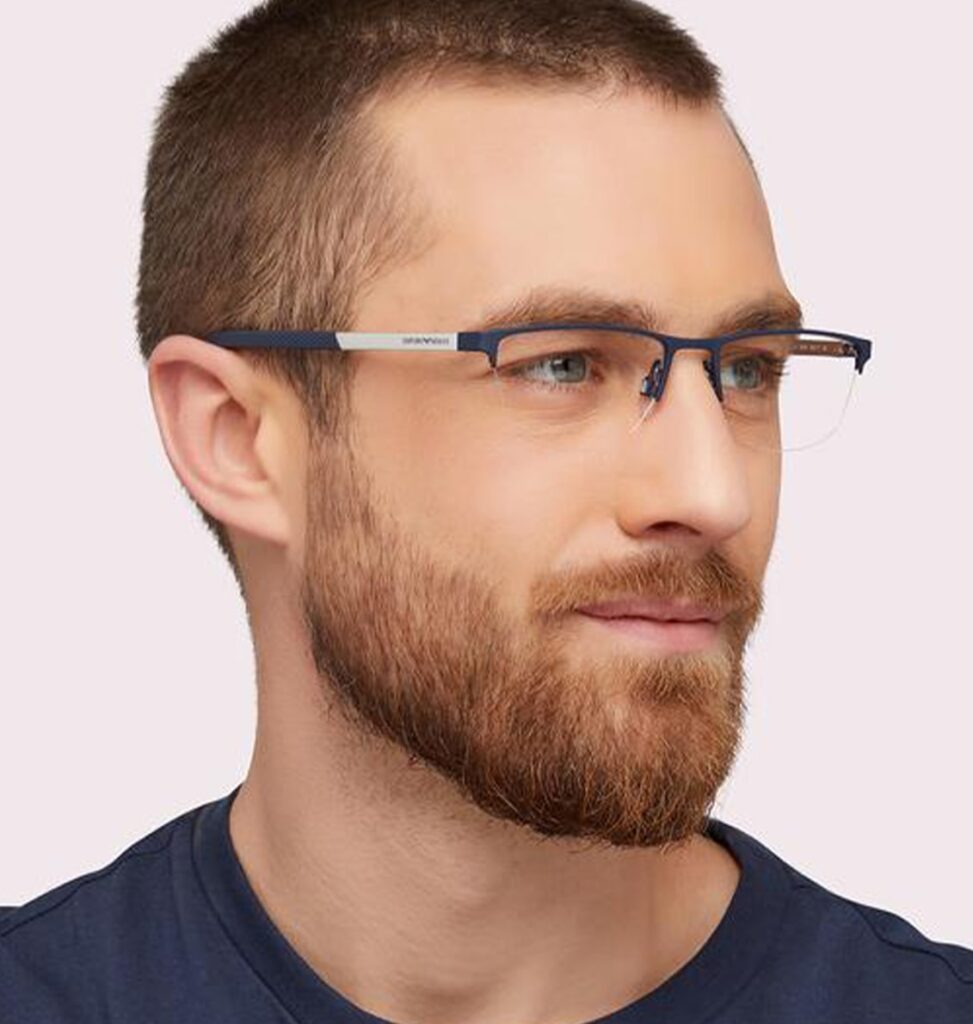 Man with a buzzcut hairstyle wearing semi-rimless blue Emporio Armani frames