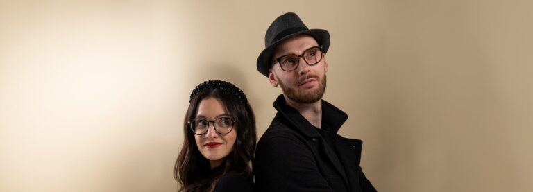 Man and woman wearing hats and glasses