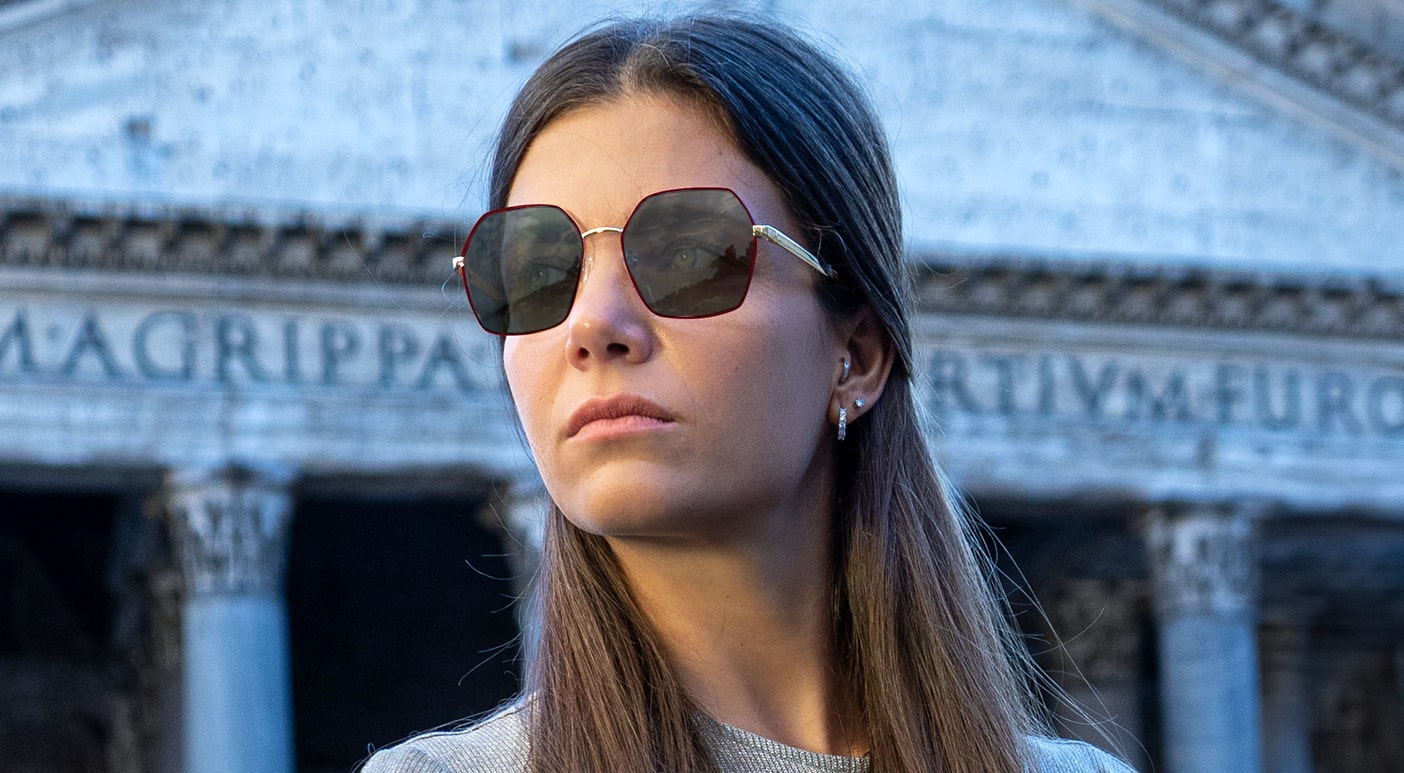 Woman wearing pink Scout Made in Italy sunglasses outdoors looking left