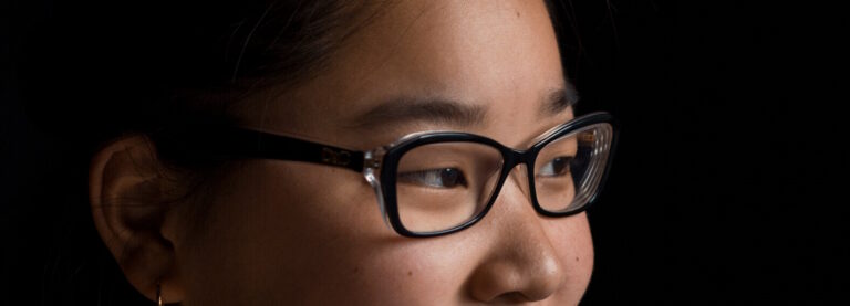 Close-up of a woman wearing rectangular glasses